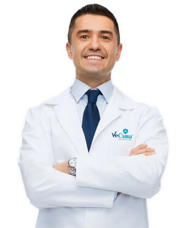 Slimming expert at Vecura Wellness Clinic in white uniform with crossed arms